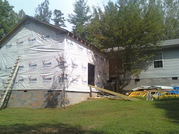 Tyvek wrapped gable on a new room addition beside an existing home in Pulaski
