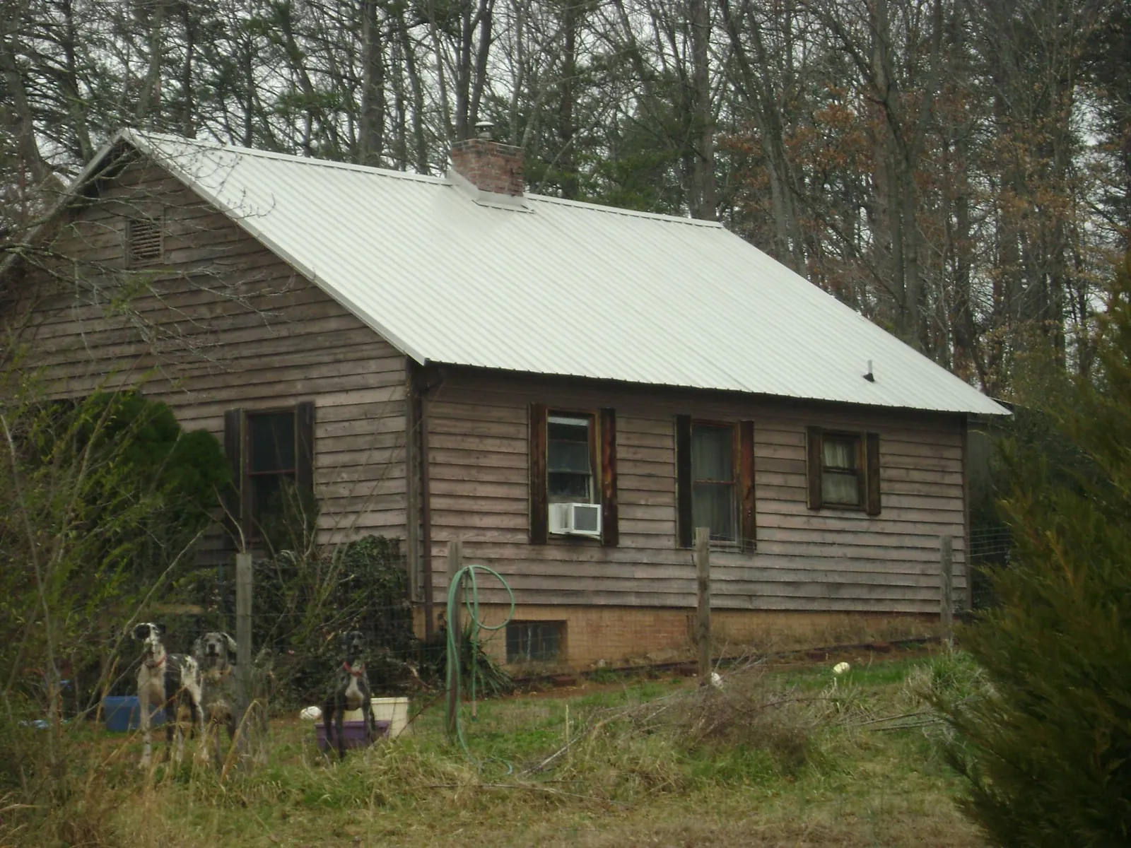 White metal roof on an old wood sided farmhouse, from a Asphalt Shingle Roof Repair job in Pulaski
